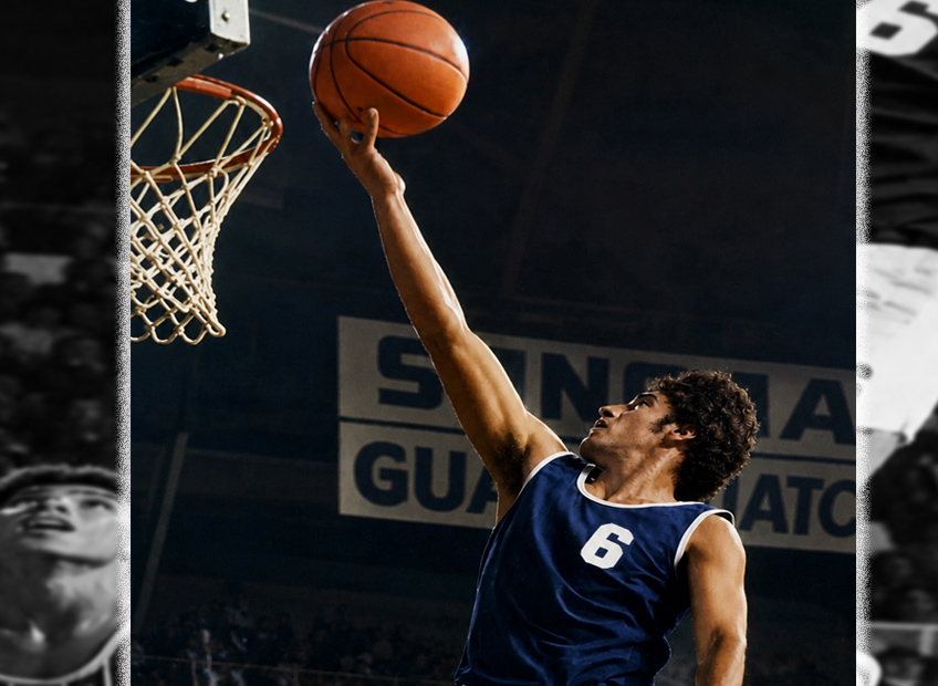 Armando "Vala" Valadez laying up the basketball in front of a packed crowd above the defenders